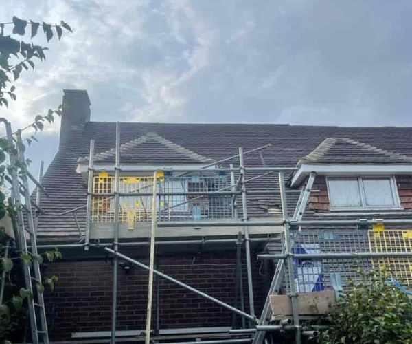 This is a photo of a roof with two dormers that is having some damaged tiles replaced. Works carried out by UG Roofing Hemsworth